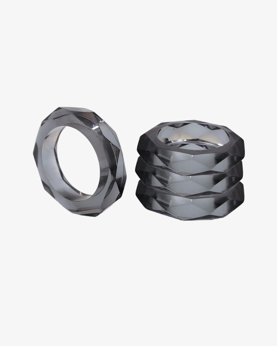A set of translucent charcoal, geometric napkin rings from the Prism Collection.